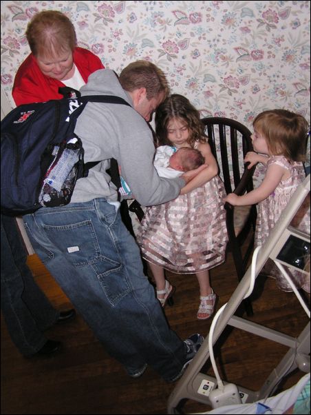 Holding new sister